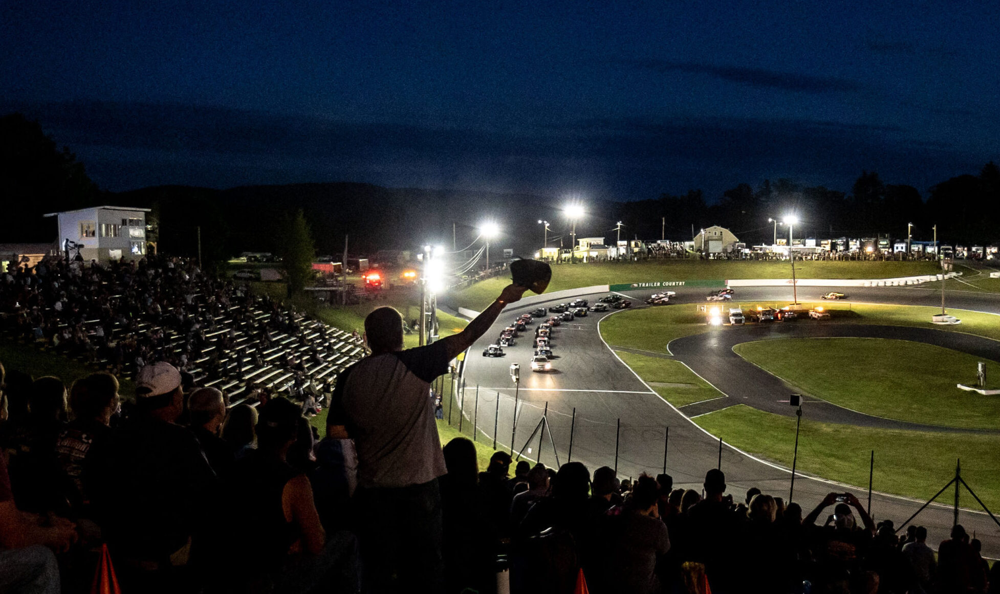 Fan in stands watching modifieds at Claremont Speedway